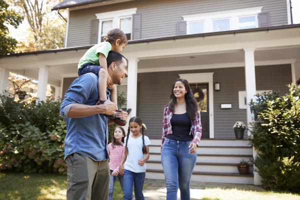 Family in front of home with new exterior siding