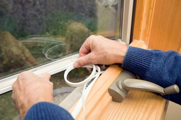 Person applying to sealant to window