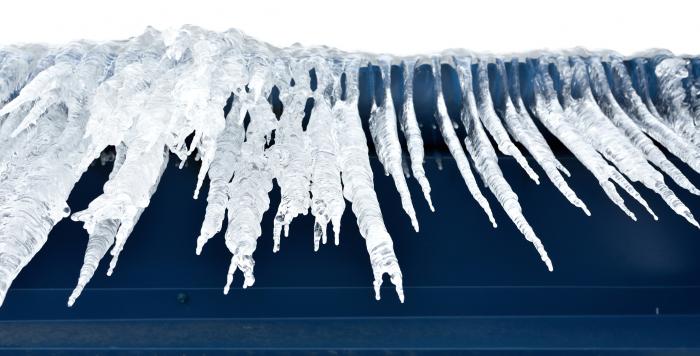 Ice dams formed at eaves of a roof.