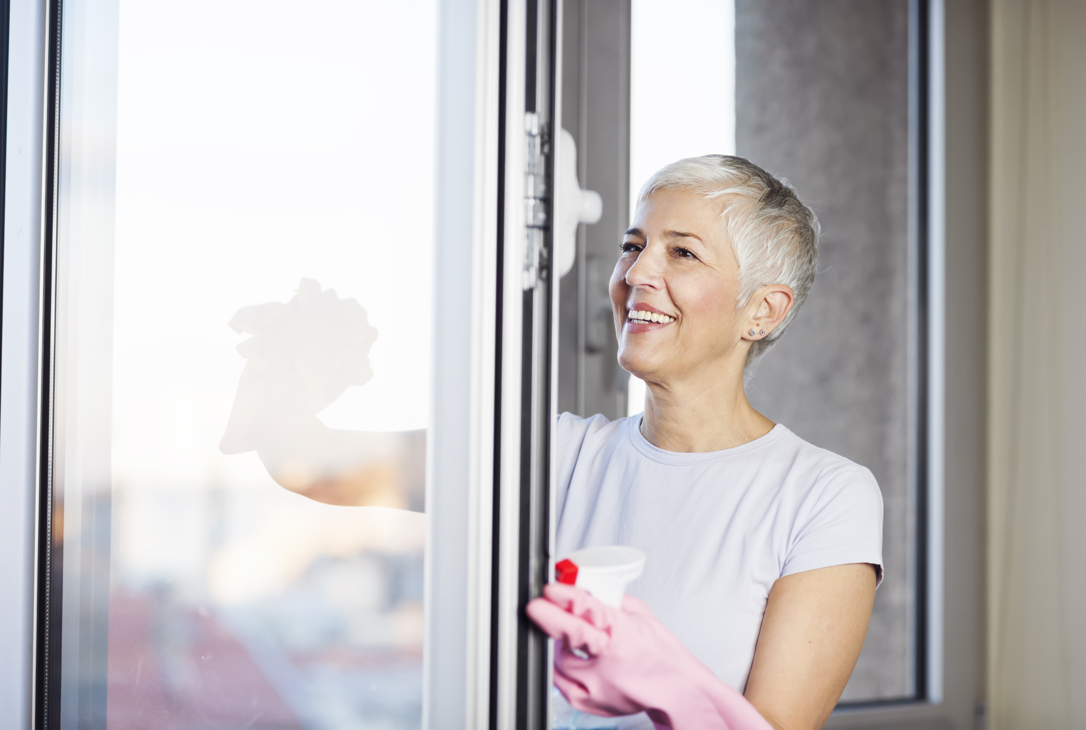 Woman cleaning her home's windows